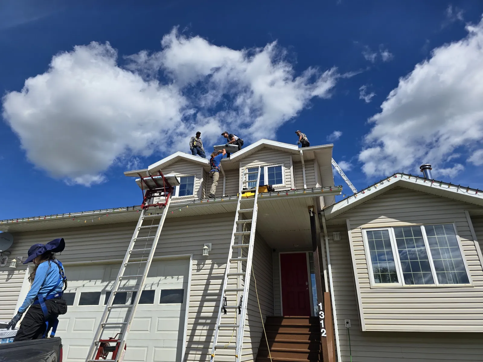 Raptor Mountain Roofing crew replacing a two-storey roof