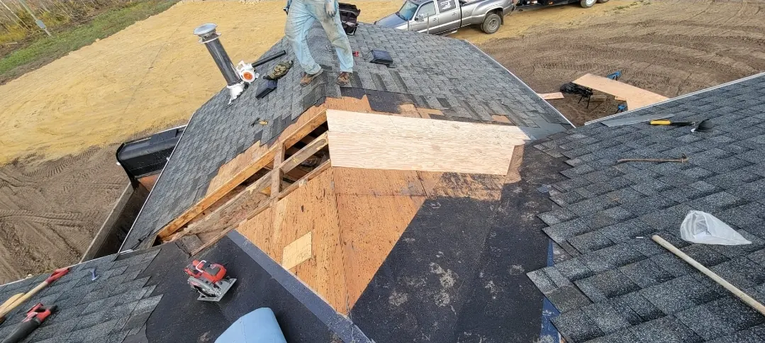 New wood framing built mid-roof during a shingle replacement, wrapped in waterproof membrane